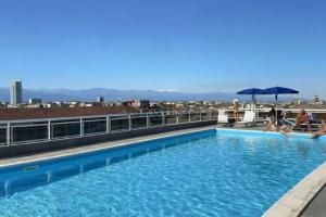 a swimming pool on the roof of a building at Moderno Attico con Vista Panoramica e Piscina in Turin