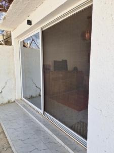 an image of a sliding glass window on a house at appartement cosy in Somone