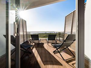 a balcony with chairs and a view of the ocean at Sofitel Quiberon Thalassa sea & spa in Quiberon +37 photos