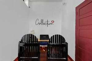 a room with two chairs and a desk with a laptop at Hotel O Valley View Residency in Vagamon +16 photos