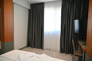 Postel nebo postele na pokoji v ubytování Adria Palace