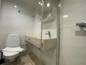 a bathroom with a sink and a toilet at Forenom Hotel Apartments Geijersgatan - City Center in Gothenburg