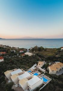 an aerial view of a resort and the ocean at Dolce Luxury Villas in Psarou