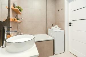 a white bathroom with a sink and a toilet at Apartament Blues, ul Jastrzębia in Lublin