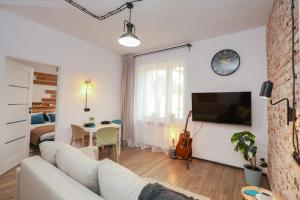 a living room with a white couch and a table at Apartament Blues, ul Jastrzębia in Lublin