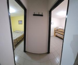 a hallway with two mirrors and a bed in a room at Apart More in Villa Mercedes
