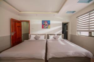 Postel nebo postele na pokoji v ubytování Dreamy Hotel Dalat