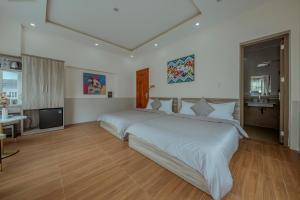Postel nebo postele na pokoji v ubytování Dreamy Hotel Dalat