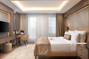 a hotel room with a large bed and a desk at Me by Mula in Istanbul