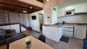 a kitchen and living room with a couch and a table at LocaGuyane in Matoury