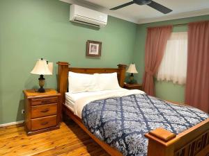 a bedroom with a bed and two night stands with lamps at Twin Treat Near Blue Mountain in Kingswood