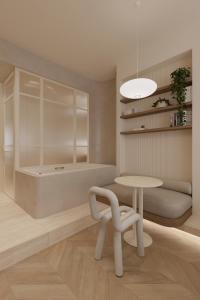 a room with a table and a chair and a tub at Luxury Living-Suite 1 in Athens