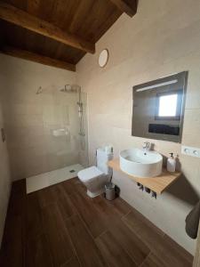 a bathroom with a sink and a toilet at Apartamentos Violante in Tuineje +54 photos