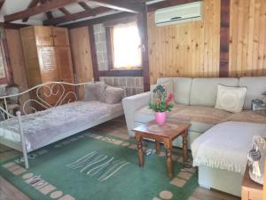 a living room with a couch and a table at Flowers Cabin in Valjevo