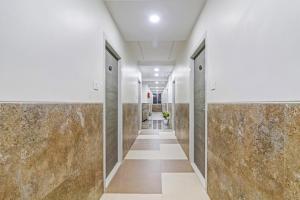 a hallway of a building with marble walls at Super Townhouse Ameerpet in Hyderabad
