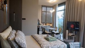 a living room with a couch and a dining room at Green Therapy Cottage in Ranau