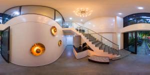 a spiral staircase in a building with a stair case at Hotel Molinos Plaza in Medellín +16 photos
