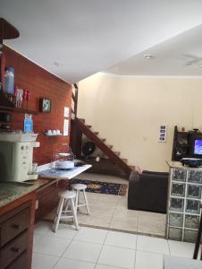 a kitchen with a sink and a staircase in a room at Casa em São Pedro da Aldeia in São Pedro da Aldeia