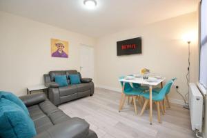 a living room with a couch and a table at Cosy 1Bed Flat with Garden, Parking & Free Netflix in Coventry