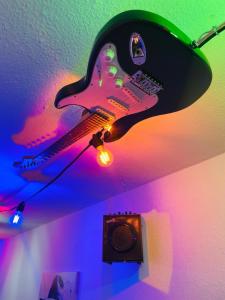 a guitar on the ceiling of a room at Music Residence in Saarbrücken