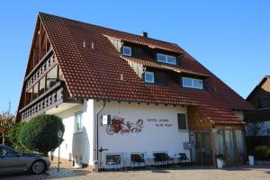a building with a sign on the side of it at Hotel Garni Alte Post in Schallbach +47 photos