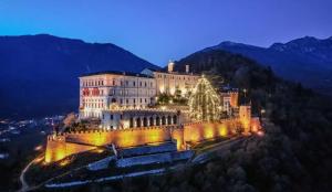 a large building on a hill with a christmas tree at Al Garofano Rosso in Cison di Valmarino