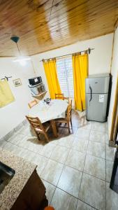a kitchen with a table and a refrigerator at Bella Vista valle del sol potrerillos in Potrerillos +16 photos