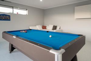 a pool table in a room with a couch at Luxury Hunter Valley Acreage - Heated SwimSpa - Mountain Views - Pool Table - Fire Pitt in Millfield