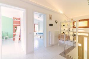 a room with a door open to a living room at Maeva Apartment in Puegnano del Garda +14 photos