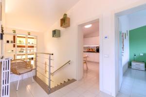a living room with a table and a chair at Maeva Apartment in Puegnano del Garda