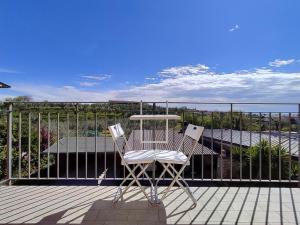 a pair of chairs sitting on a deck at Maeva Apartment in Puegnano del Garda