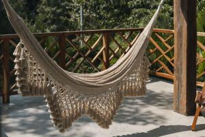 a hammock hanging from a wooden fence at Large 6BR Tulum Villa with Pool Aldea Zama in Tulum