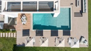 an overhead view of a swimming pool with chairs and a swimming pool at Armonia Luxury Villa in Triánta