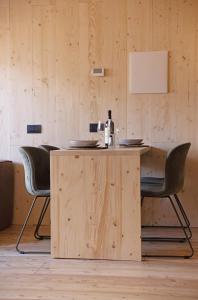a wooden table with black chairs around it at Cervino loft in Breuil-Cervinia