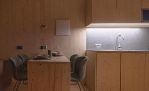 a kitchen with a table with chairs and a sink at Cervino loft in Breuil-Cervinia