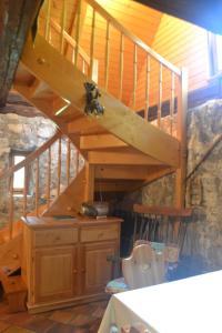 a bathroom with a toilet under a wooden staircase at House Pod Lipo in Trenta