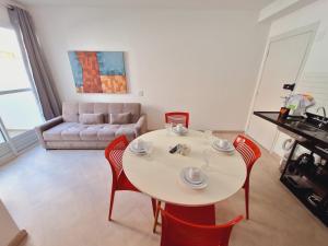 a living room with a table and chairs and a couch at LK Centro 2 in Belo Horizonte
