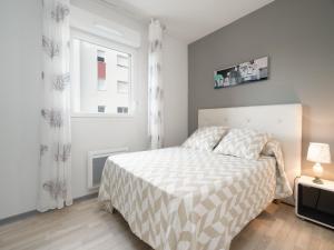a white bedroom with a bed and a window at La DUNE N 01 - VILLA 3P6 in Valras-Plage +20 photos