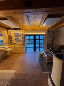 a large kitchen with wooden floors and a large window at Alice Chalet Bled - Adults only in Bled