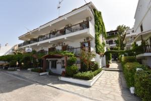 a building with ivy on the side of it at Argo Apartments in Nea Potidaea