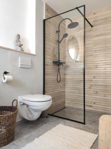 a bathroom with a toilet and a glass shower at Chata Fraluq in Tatobity +21 photos