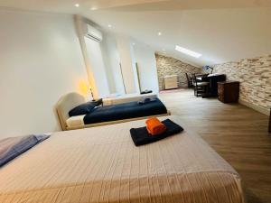 a bedroom with two beds and a desk in a room at Castle House Loulé City Center in Loulé