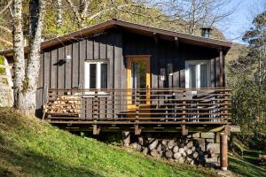 a small cabin on a hill in the woods at Le Clou in Thiézac
