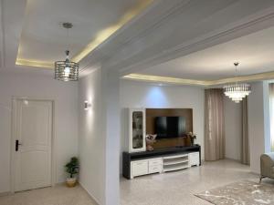 a living room with a tv and a couch at Dar Sammoud A1 in Kelibia