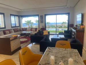 a living room with a couch and a table and chairs at Villa Casa Deraoui in Tangier