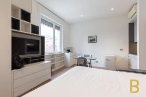 Televízia a/alebo spoločenská miestnosť v ubytovaní BePlace Garibaldi Suites