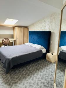 a bedroom with a bed and a chair in it at Hotel Plaza in Craiova +36 photos