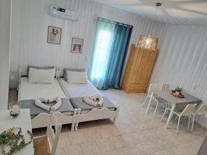 a bedroom with a bed and a table and chairs at Orion Studios in Alonnisos