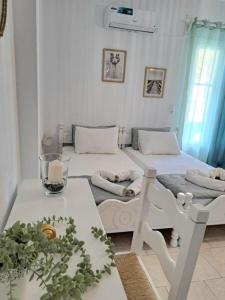 a living room with two beds and a table at Orion Studios in Alonnisos