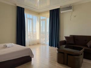 a living room with a bed and a couch at GT House Batumi in Batumi +82 photos